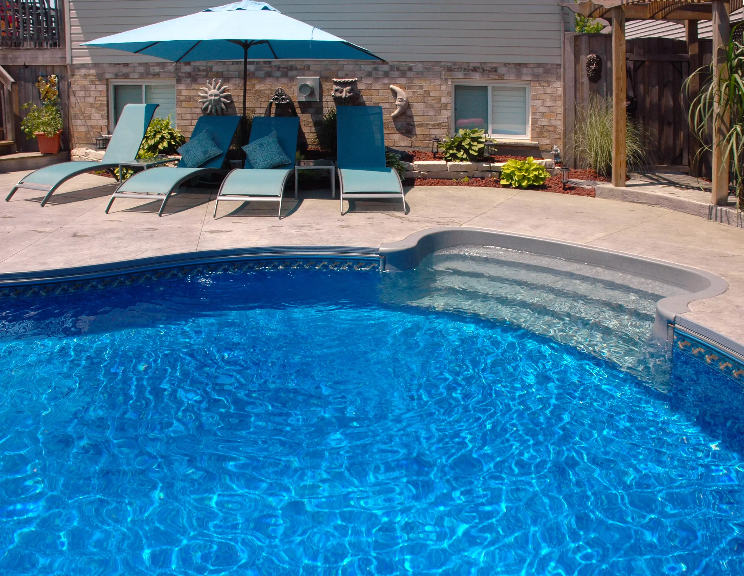 pool siding and stairs with chairs in background