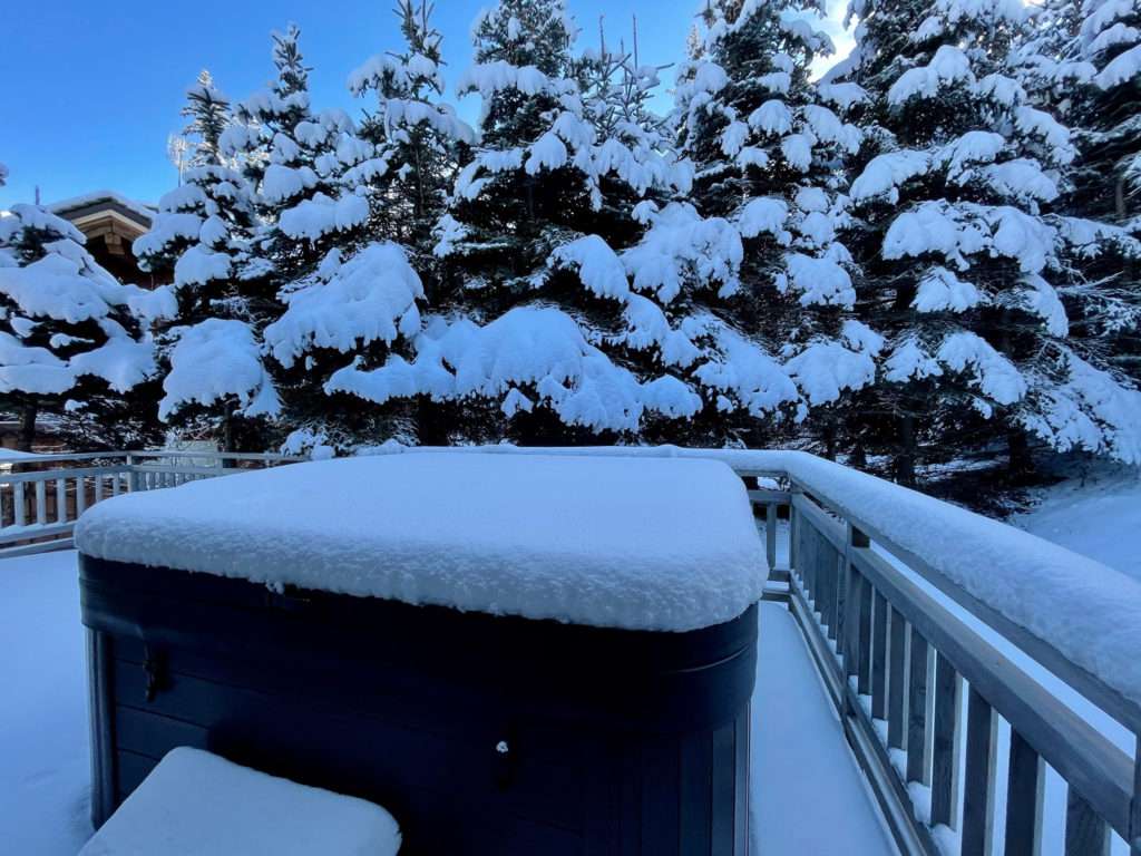 outdoor hot tub covered in snow